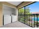 Relaxing balcony featuring a washer/dryer hookup and a peaceful view of the community pool at 4991 Puritan Cir # 522, Tampa, FL 33617
