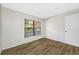 Neutral bedroom featuring wood-look flooring, a window, and a bright interior at 4991 Puritan Cir # 522, Tampa, FL 33617
