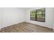 Bedroom with a large window and wood-look flooring at 4991 Puritan Cir # 522, Tampa, FL 33617