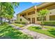 Attractive condo building featuring manicured landscaping, walkways, and classic architecture at 4991 Puritan Cir # 522, Tampa, FL 33617