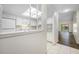 Bright kitchen with white cabinetry, tile flooring, and an overhead skylight for natural lighting at 4991 Puritan Cir # 522, Tampa, FL 33617