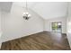 Open living room with vaulted ceiling, wood flooring, and a sliding glass door to the outside at 4991 Puritan Cir # 522, Tampa, FL 33617