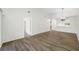 Spacious living room featuring hardwood floors, modern lighting, and open access to the kitchen at 4991 Puritan Cir # 522, Tampa, FL 33617