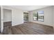 Bright living room featuring wood-look flooring, a sliding glass door, and a window at 4991 Puritan Cir # 522, Tampa, FL 33617