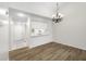 Open floorplan featuring hardwood floors, modern lighting, and open access to the kitchen at 4991 Puritan Cir # 522, Tampa, FL 33617