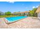 Community pool with brick patio, surrounded by mature trees for a serene outdoor setting at 4991 Puritan Cir # 522, Tampa, FL 33617