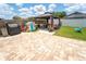 Spacious backyard featuring a charming gazebo, perfect for outdoor entertaining and relaxation, surrounded by a well-maintained lawn at 518 Greg St, Valrico, FL 33594