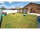 Spacious backyard with lush green lawn, perfect for outdoor activities and relaxation, featuring a basketball hoop at 518 Greg St, Valrico, FL 33594