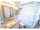 Cozy bathroom with a granite countertop, white vanity, and stylish striped shower curtain at 518 Greg St, Valrico, FL 33594