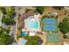 An aerial view showcases a stunning community pool with tennis and basketball courts, alongside a playground at 518 Greg St, Valrico, FL 33594
