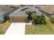 Charming, single-story home boasts a well-manicured lawn, mature landscaping, and an attached two-car garage at 518 Greg St, Valrico, FL 33594