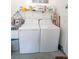 Functional laundry room with a washer, dryer, and storage shelf for laundry supplies at 518 Greg St, Valrico, FL 33594