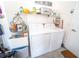 Bright laundry room featuring modern washer and dryer, ample storage and organized shelving for supplies at 518 Greg St, Valrico, FL 33594