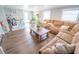 Comfortable living room with hardwood floors, a sectional sofa, and plenty of natural light at 518 Greg St, Valrico, FL 33594