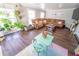 Inviting living room with hardwood floors, large sectional sofa, and a decorative table at 518 Greg St, Valrico, FL 33594