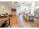 Open-concept living area includes hardwood floors, a stylish sofa, and a seamless transition to the modern kitchen at 518 Greg St, Valrico, FL 33594