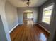 Dining room boasts shiny hardwood floors, arched doorway, and natural light from a large window, creating an inviting space at 536 89Th N Ave, St Petersburg, FL 33702