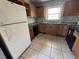 Functional kitchen with appliances, ample cabinet space, and tiled floors, ready for your personal touch at 536 89Th N Ave, St Petersburg, FL 33702