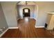 Open-concept living room with hardwood floors, arched openings, and a fireplace, perfect for gatherings at 536 89Th N Ave, St Petersburg, FL 33702