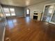 Spacious living room featuring hardwood floors, a fireplace, and large windows that provide natural light throughout at 536 89Th N Ave, St Petersburg, FL 33702