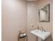 Cozy powder room showcasing a pedestal sink, a decorative mirror, and tasteful wallpaper, maximizing style in a small space at 555 5Th Ne Ave # 424, St Petersburg, FL 33701