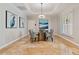 Elegant dining room featuring a glass table, stylish chairs, tray ceiling, and decorative wall art at 555 5Th Ne Ave # 424, St Petersburg, FL 33701