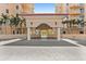 Elegant porte cochere with pillars providing access to the condo building, surrounded by palm trees at 555 5Th Ne Ave # 424, St Petersburg, FL 33701