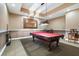 Well-appointed game room with a red felt pool table, overhead lighting, and comfortable seating at 555 5Th Ne Ave # 424, St Petersburg, FL 33701