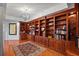 Living room featuring custom built-in bookshelves, hardwood floors, and a decorative rug at 555 5Th Ne Ave # 424, St Petersburg, FL 33701