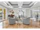 Comfortable lounge area with plush seating, marble floors, and French doors to an outdoor patio at 555 5Th Ne Ave # 424, St Petersburg, FL 33701