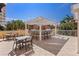 Wonderful outdoor kitchen with bar-style seating under a pergola and lush tropical views, offering an inviting outdoor lifestyle at 555 5Th Ne Ave # 424, St Petersburg, FL 33701