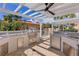 Outdoor kitchen featuring stainless steel appliances, marble countertops, and a built-in grill for elevated outdoor cooking at 555 5Th Ne Ave # 424, St Petersburg, FL 33701