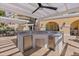 Outdoor kitchen complete with stainless steel appliances, a sink, and bar seating at 555 5Th Ne Ave # 424, St Petersburg, FL 33701