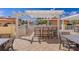 This outdoor kitchen features stainless steel grill and bar seating under a white pergola, creating the ultimate entertaining space at 555 5Th Ne Ave # 424, St Petersburg, FL 33701