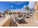 Spacious outdoor patio featuring multiple seating areas, pergolas, an outdoor grill, and beautiful views of the surrounding area at 555 5Th Ne Ave # 424, St Petersburg, FL 33701