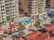 Aerial view showcasing the community pool and condo buildings with beautiful palm trees at 555 5Th Ne Ave # 424, St Petersburg, FL 33701