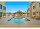 Beautiful outdoor pool area surrounded by lounge chairs, lush greenery, and elegant residential buildings at 555 5Th Ne Ave # 424, St Petersburg, FL 33701