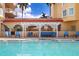 Beautiful pool area with lounge seating and a white pergola providing shade near the building at 555 5Th Ne Ave # 424, St Petersburg, FL 33701