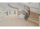 Elegant lobby featuring a curved staircase with iron railings, and a mirrored wall at 555 5Th Ne Ave # 424, St Petersburg, FL 33701
