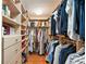 Spacious walk-in closet with custom shelving, drawers, and hanging rods for ample storage with hardwood floors at 555 5Th Ne Ave # 424, St Petersburg, FL 33701