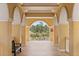 Elegant walkway with arched openings providing serene views of landscaped gardens and secure gated access at 555 5Th Ne Ave # 424, St Petersburg, FL 33701