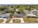Aerial view of the property featuring a well maintained front yard, driveway and mature trees at 5660 Hobson Ne St, St Petersburg, FL 33703