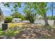 View of the backyard featuring a large storage shed, green grass, and a privacy fence at 5660 Hobson Ne St, St Petersburg, FL 33703