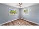 Cozy bedroom with wood floors, ample natural light, and a view of the neighborhood at 5660 Hobson Ne St, St Petersburg, FL 33703