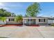 Charming single-story home with a well-manicured front yard, palm trees and a spacious driveway at 5660 Hobson Ne St, St Petersburg, FL 33703