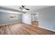 Open-concept living room with vaulted ceilings, wood flooring, and plenty of natural light at 5660 Hobson Ne St, St Petersburg, FL 33703