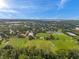 Aerial view of a large sports field surrounded by trees and a distant cityscape on the horizon at 5660 Hobson Ne St, St Petersburg, FL 33703