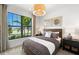 Comfortable bedroom retreat features a large window, stylish decor, and ample natural light at 5703 Silverside Pine Ct, Lakewood Ranch, FL 34211