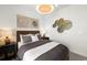 Well-decorated bedroom with neutral color palette, stylish art, and ample natural light at 5703 Silverside Pine Ct, Lakewood Ranch, FL 34211