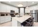 Open kitchen featuring quartz countertops, stainless appliances, and a center island at 5703 Silverside Pine Ct, Lakewood Ranch, FL 34211